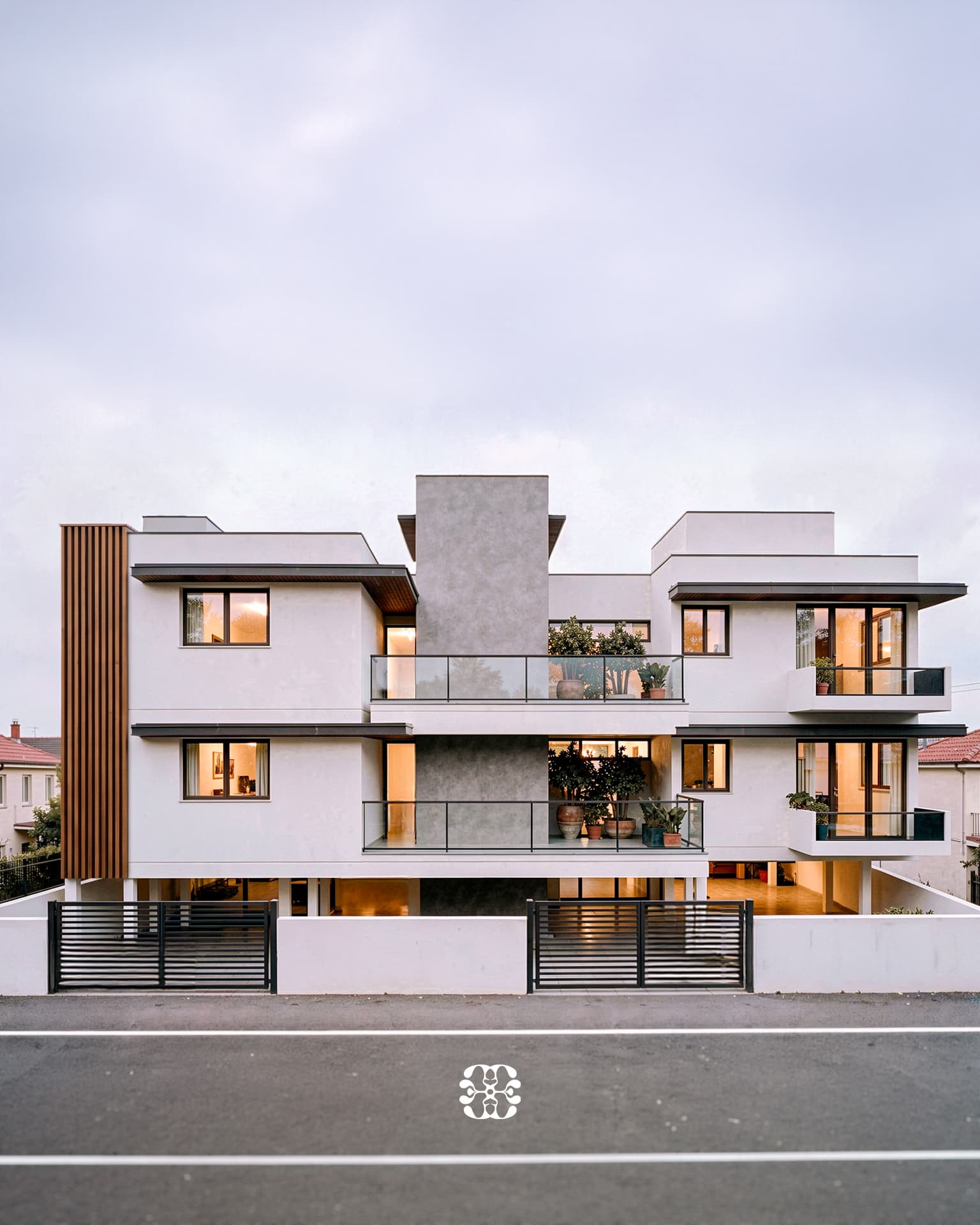 Kumbakonam apartment concept with white volumes, textured grey walls, timber-toned fins and planted balconies